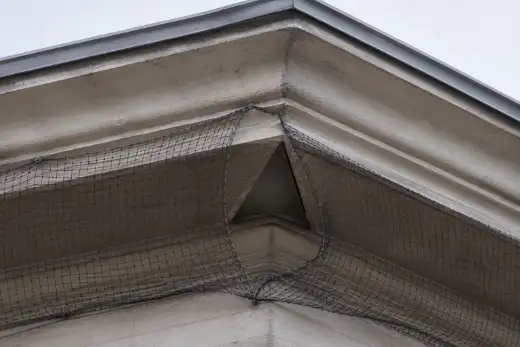Rete anti volatili allentata con una vistosa apertura triangolare all’angolo del fissaggio